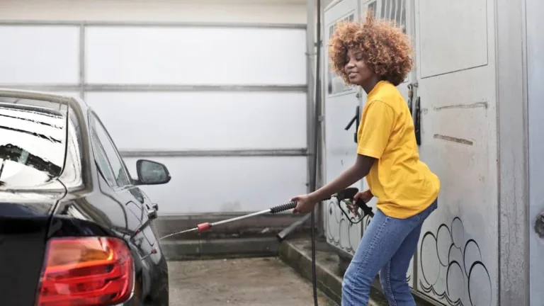 girl in yellow detailing black car