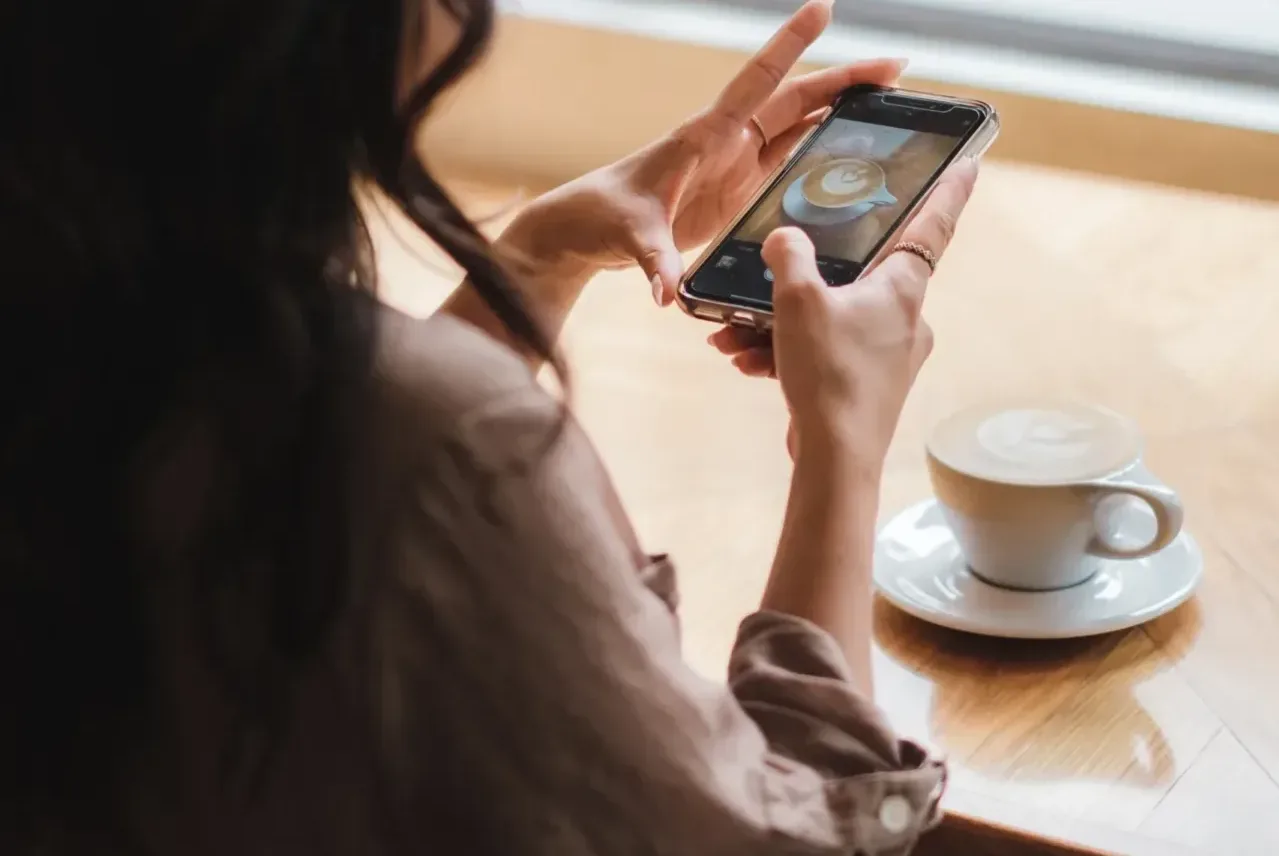 woman enjoying a cup of coffee from the best k-cup coffee maker